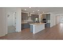 Modern kitchen with gray cabinets, stainless steel appliances, and a central island at 4050 W Nora Dr, San Tan Valley, AZ 85144