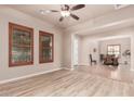 Spacious living room featuring wood floors, neutral paint and direct access to the dining area at 4318 N 180Th Dr, Goodyear, AZ 85395