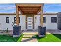 Inviting front porch with wood beam features and modern accents at 4809 N 30Th Pl, Phoenix, AZ 85016