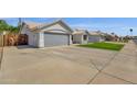 Exterior showcasing a paved driveway leading to a grey two car garage at 5258 E Elena Ave, Mesa, AZ 85206