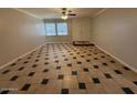 Open living room featuring tile floors and a view of the front yard through a window at 5639 N 46Th Ave, Glendale, AZ 85301