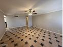 Spacious living room with a ceiling fan and tile flooring in a unique pattern at 5639 N 46Th Ave, Glendale, AZ 85301
