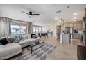Open concept living area with a large sectional and light wood floors at 734 E Doral Ave # 202, Gilbert, AZ 85297