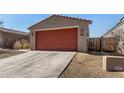 Cozy single-story home featuring a red garage door and a concrete driveway at 7456 N 126Th Ln, Glendale, AZ 85307