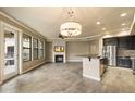 Open living room with tile floors, a ceiling fan, a fireplace, and an adjacent kitchen space at 7601 E Indian Bend Rd # 2056, Scottsdale, AZ 85250