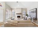 Bright living room featuring arched windows, vaulted ceilings and cozy fireplace at 7955 E Chaparral Rd # 115, Scottsdale, AZ 85250