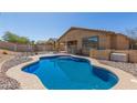 Private pool with patio seating provides a relaxing space in this home's backyard at 10287 S 175Th Ave, Goodyear, AZ 85338
