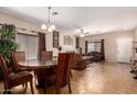Open-concept living area with a dining table set and comfortable seating, perfect for entertaining at 11872 W Sherman St, Avondale, AZ 85323