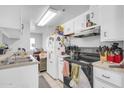 Bright kitchen with white cabinets, modern appliances, and ample counter space at 12123 W Bell Rd # 315, Surprise, AZ 85378