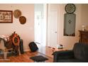 Eclectic living room featuring unique wall decor and comfortable seating area at 16120 W Kendall St, Goodyear, AZ 85338