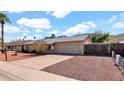 This property has a spacious driveway, two car garage, and low maintenance landscaping, ideal for convenient suburban living at 1633 W Andorra Dr, Phoenix, AZ 85029
