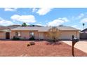 Inviting single-level home with a two-car garage and desert-style landscaping, offering a blend of comfort and easy maintenance at 1633 W Andorra Dr, Phoenix, AZ 85029