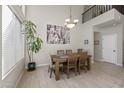 A formal dining room with a chandelier and a neutral color scheme at 1785 S Morrison Ln, Gilbert, AZ 85295