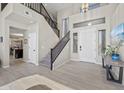 Bright foyer featuring a staircase, high ceilings, and tile flooring throughout at 1785 S Morrison Ln, Gilbert, AZ 85295