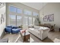 Bright living room featuring high ceilings, large windows, and an open floor plan at 1785 S Morrison Ln, Gilbert, AZ 85295