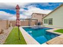 Backyard pool with clear blue water, desert landscaping, and shaded lounge area, great for entertaining at 25844 W Watkins St, Buckeye, AZ 85326