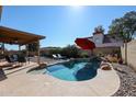 Inviting backyard features a private pool, covered patio, and lush landscaping perfect for outdoor relaxation at 2810 S Emerson --, Mesa, AZ 85210