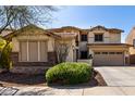 Charming two-story home with stone accents, a well manicured yard, and mature landscaping at 29374 N 125Th Dr, Peoria, AZ 85383