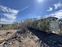 Desert property with dilapidated structure; rugged landscape, and bright sky at 3200 S Mesa Rd, Winkelman, AZ 85192