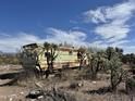 Desert property featuring weathered exterior, cacti, and natural desert setting at 3200 S Mesa Rd, Winkelman, AZ 85192