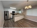 Bright kitchen features white cabinets, stainless steel appliances, and a breakfast bar at 3515 E Winchcomb Dr, Phoenix, AZ 85032