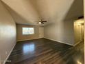 The living room has beautiful wood flooring, a ceiling fan, and plenty of natural light at 3515 E Winchcomb Dr, Phoenix, AZ 85032