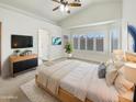 Bright main bedroom with plantation shutters, wood floors, ceiling fan, and a decorative cowhide rug at 3527 N Kashmir --, Mesa, AZ 85215