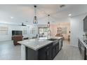 A modern kitchen with granite countertops, a large island, and stainless steel appliances at 37051 N Rhinelander Dr, San Tan Valley, AZ 85140