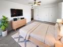 Comfortable bedroom with a large bed, soft carpet, and ample closet space at 4119 N 78Th Ave, Phoenix, AZ 85033