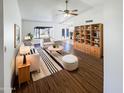 Bright living room showcasing modern decor, hardwood floors, and a stylish bookcase at 4119 N 78Th Ave, Phoenix, AZ 85033