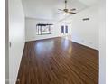 Spacious living room with hardwood floors and a large window offering plenty of natural light at 4119 N 78Th Ave, Phoenix, AZ 85033