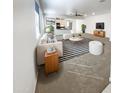 Bright, open-concept living room with modern furnishings, including a comfortable sofa and a striped rug at 4127 W Acorn Valley Trl, New River, AZ 85087