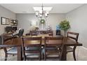Formal dining room featuring stylish chandelier, neutral tones, and a built-in workstation at 419 N Valencia Dr, Chandler, AZ 85226