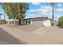 Cozy home with drought resistant landscaping, two-car garage, and neutral color scheme at 419 N Valencia Dr, Chandler, AZ 85226