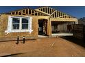 Exterior view of a new home under construction with visible frame, window opening, and garage at 4296 E Brook Lynn Pl, San Tan Valley, AZ 85140
