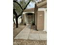 Inviting front entrance with a security door, desert landscaping, and a well-maintained walkway at 4402 E Creosote Dr, Cave Creek, AZ 85331