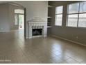 Spacious living room with tile flooring and a fireplace, perfect for entertaining and relaxation at 4402 E Creosote Dr, Cave Creek, AZ 85331