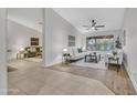 Bright living room with white sofas, neutral rug, and a view to the backyard through large sliding glass doors at 446 W Sereno Dr, Gilbert, AZ 85233