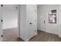Bright entryway featuring wood-look flooring, and white doors at 501 E 2Nd Ave # 14, Mesa, AZ 85204