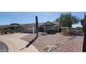 Single level home with desert landscaping, stone accents, and tile roof in a sunny neighborhood at 6005 E Selkirk Cir, Mesa, AZ 85215