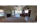 Open floor plan featuring a fireplace, tile flooring, and a kitchen with an island at 6005 E Selkirk Cir, Mesa, AZ 85215