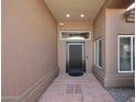 Covered entryway featuring a modern front door and a tiled floor, leading into the home at 6323 E Nisbet Rd, Scottsdale, AZ 85254