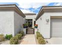 Inviting front entrance with desert landscaping and decorative plants leading to a glass front door at 6340 E Marioca Cir, Scottsdale, AZ 85266