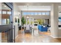 Open-concept living room and dining area featuring high ceilings, large windows, and tile flooring at 6340 E Marioca Cir, Scottsdale, AZ 85266