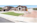 Well-maintained home with a neutral color scheme, 2-car garage, and manicured front yard at 6920 W Tether Trl, Peoria, AZ 85383