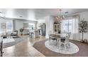 Bright dining room with pool view and chandelier, adjacent to a modern kitchen at 7015 S Stadium Ct, Gilbert, AZ 85298