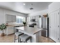 Modern kitchen with stainless steel appliances, island seating, and ample counter space at 7015 S Stadium Ct, Gilbert, AZ 85298