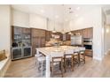 The spacious kitchen features an island with seating, pendant lighting, and high-end stainless steel appliances at 7739 E Evening Glow Dr, Scottsdale, AZ 85266