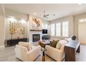 Bright living room boasts a fireplace, ceiling fan, and neutral colors, perfect for relaxation and entertaining guests at 7739 E Evening Glow Dr, Scottsdale, AZ 85266