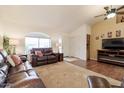 Inviting living room with a vaulted ceiling, ceiling fan, and comfortable leather furniture at 7942 E Nopal Ave, Mesa, AZ 85209